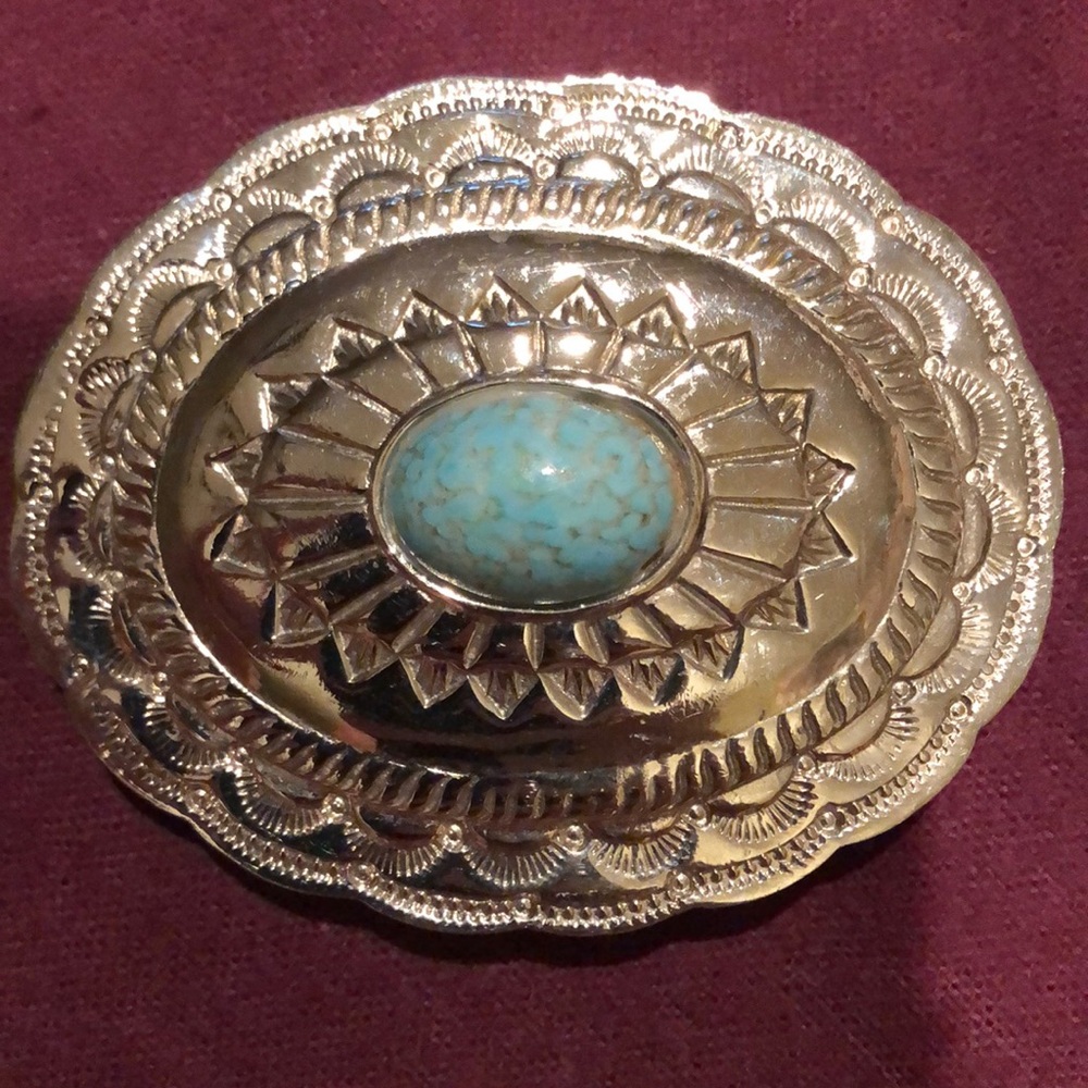 Silver Buckle with light turquoise in center.